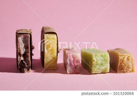 Still life with series of organic soap bars and dry solid shampoos with natural ingredients on pink isolated background. The concept of skin, body and hair care. Cleanliness, hygiene, beauty, home spa 101320068