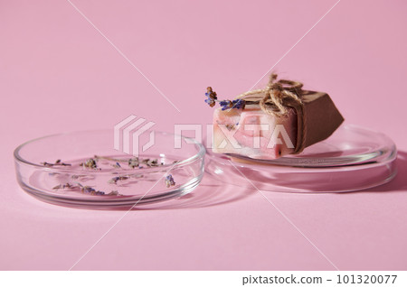 Details on a bar of handmade organic soap of pink marble color with natural ingredients, on petri dish with dry lavender flowers, isolated pink background. Skin and body care. Hygiene Purity Home Spa Details on a bar of handmade organic soap of pink marble color with natural ingredients, on petri dish with dry lavender flowers, isolated pink background. Skin and body care. Hygiene Purity Home Spa 101320077