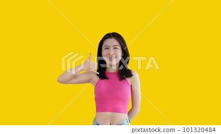 Call sign, Bright young asian woman inviting to call isolated on yellow background, Suggest to call or invite to apply for membership, Isolated on yellow background. 101320484