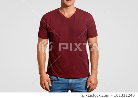Indoor cropped image of muscular young man in red t shirt and jeans, stands against white background, poses over white background, blank space or your logo or advertisement. Clothing concept Indoor cropped image of muscular young man in red t shirt and jeans, stands against white background, poses over white background, blank space or your logo or advertisement. Clothing concept 101321246