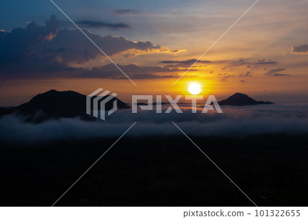 Beautiful dramatic sunset in the mountains. Landscape lot of fog Phu Thok Mountain at Chiang Khan ,Loei Province in Thailand. Beautiful dramatic sunset in the mountains. Landscape lot of fog Phu Thok Mountain at Chiang Khan ,Loei Province in Thailand. 101322655