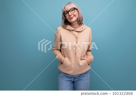 portrait of a dreamy mature woman with gray hair in a casual look on a studio background with copy portrait of a dreamy mature woman with gray hair in a casual look on a studio background with copy 101322808