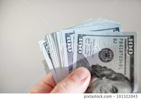 Close up male hand Counting and holding money us dollar. 101322843