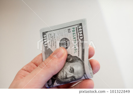 Close up male hand Counting and holding money us dollar. 101322849