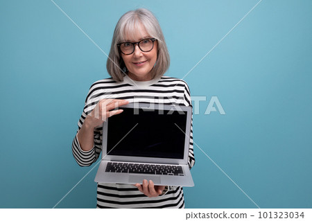 modern middle aged woman holding pc with advertising mockup on bright studio background 101323034