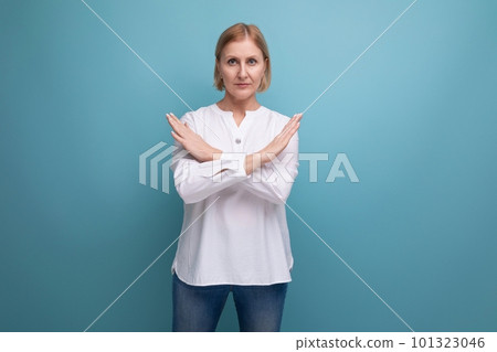 blond mature woman in white blouse showing refusal gesture with hands blond mature woman in white blouse showing refusal gesture with hands 101323046