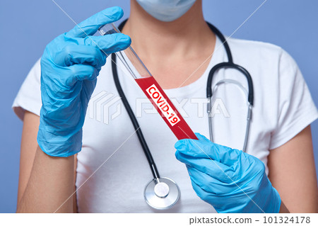 feceless portrait of doctor analyzes tubes of blood in lab, medical staff checked sample at hospital, lady wearing white shirt and disposable gloves, posing isolated over blue studio background. feceless portrait of doctor analyzes tubes of blood in lab, medical staff checked sample at hospital, lady wearing white shirt and disposable gloves, posing isolated over blue studio background. 101324178