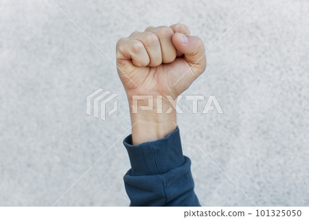 Unknown person protesting, activist fist up during strike. Activism for equal human rights or against racism, faceless human upraising fist isolated over white background. 101325050