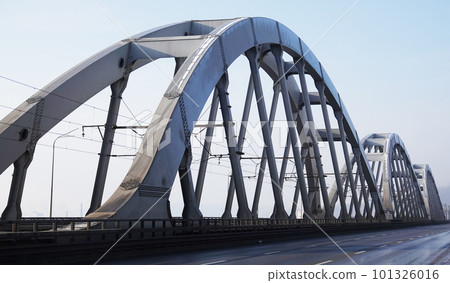 Kiev, Ukraine January 23, 2021: A train rides across the Railway Bridge Kiev, Ukraine January 23, 2021: A train rides across the Railway Bridge 101326016