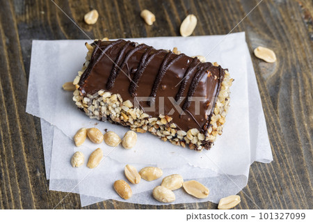 Fresh sweet cake with banana in chocolate glaze and milk filling 101327099