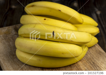 a bunch of bananas lies on the table a bunch of bananas lies on the table 101327196