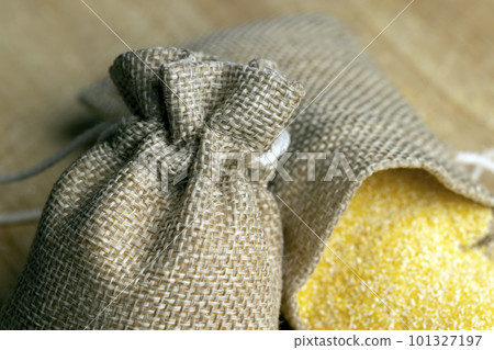 Linen bag of small size with dry corn flour for cooking porridge Linen bag of small size with dry corn flour for cooking porridge 101327197