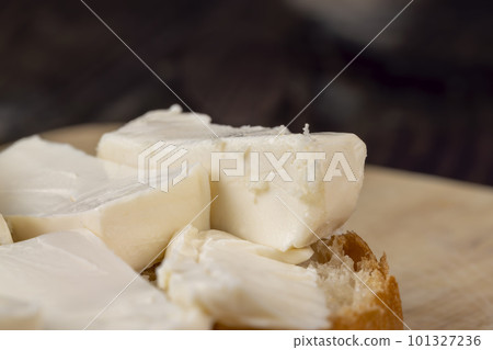Wheat bun with large pieces of processed cheese inside Wheat bun with large pieces of processed cheese inside 101327236