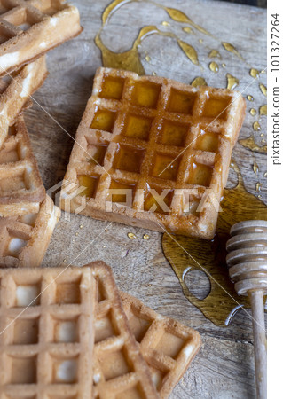 Soft fresh waffles with bee honey close-up 101327264