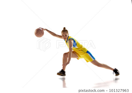 Young girl, concentrated basketball player in motion, training, dribbling ball against white studio background. Concept of professional sport 101327963