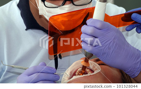 Kiev, Ukraine August 22, 2020: Dentist doctor works with a patient close-up Kiev, Ukraine August 22, 2020: Dentist doctor works with a patient close-up 101328044