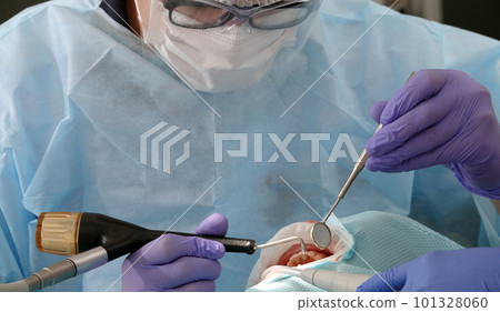 Kiev, Ukraine August 22, 2020: Dentist doctor works with a patient close-up Kiev, Ukraine August 22, 2020: Dentist doctor works with a patient close-up 101328060
