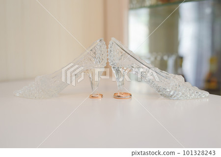 Gold wedding rings and crystal shoes 101328243