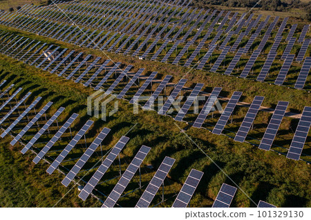 Aerial view flying over a solar panel farm Aerial view flying over a solar panel farm 101329130