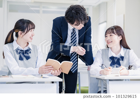 High school student receiving guidance from a teacher 101329615