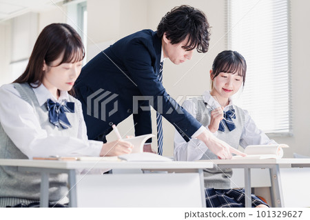 High school student receiving guidance from a teacher 101329627