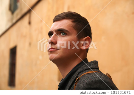 Portrait young man on aged yellow background. Serious young man. 20s years. Handsome man outdoors portrait. Walking lifestyle. Student. Out of focus Portrait young man on aged yellow background. Serious young man. 20s years. Handsome man outdoors portrait. Walking lifestyle. Student. Out of focus 101331671