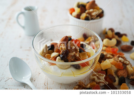 Yogurt with nuts and dried fruits, sprinkled with honey Yogurt with nuts and dried fruits, sprinkled with honey 101333058