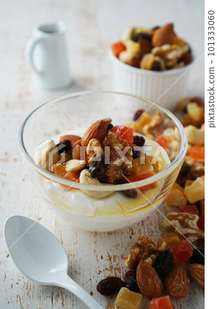 Yogurt with nuts and dried fruits, sprinkled with honey Yogurt with nuts and dried fruits, sprinkled with honey 101333060