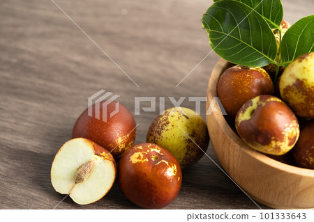 Jujube fruit or Chinese Dates in wooden bowl, healthy food. 101333643