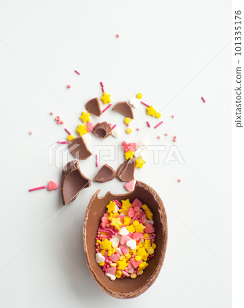Colorful and chocolate easter eggs with sweet dragee on white background 101335176