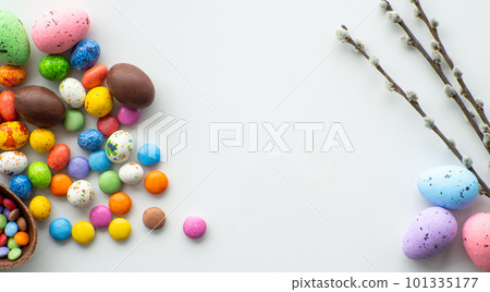 Colorful and chocolate easter eggs with sweet dragee on white background 101335177