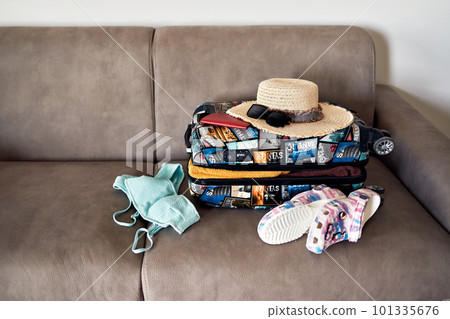 Luggage and suitcase packing for vacation on the bed, closeup Luggage and suitcase packing for vacation on the bed, closeup 101335676