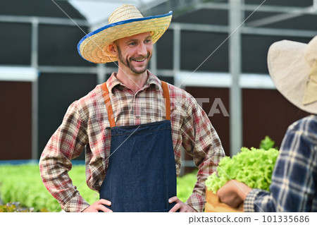 Smiling agriculture business owner talking with costumer in hydroponics greenhouse plantation 101335686