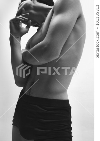 Cropped black and white image of young guy posing shirtless in underwear against white background. Muscular relief body Cropped black and white image of young guy posing shirtless in underwear against white background. Muscular relief body 101335813