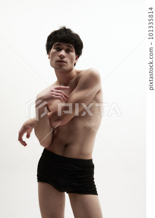 Portrait of young asian man posing in black underwear against white studio background. Relief, fit, strong male body Portrait of young asian man posing in black underwear against white studio background. Relief, fit, strong male body 101335814