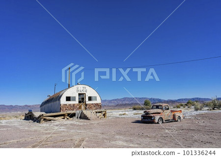 Sunny view of an abandoned house, car at Tecopa 101336244