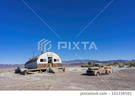 Sunny view of an abandoned house, car at Tecopa 101336502