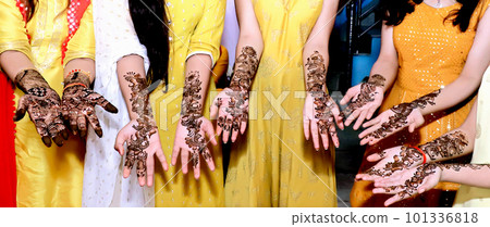 Beautiful artwork drawn on the hand of an Indian bride with herbal heena in wet condition. Beautiful artwork drawn on the hand of an Indian bride with herbal heena in wet condition. 101336818
