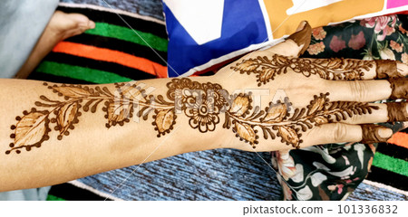 Beautiful artwork drawn on the hand of an Indian bride with herbal heena in wet condition. Beautiful artwork drawn on the hand of an Indian bride with herbal heena in wet condition. 101336832