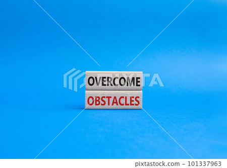 Overcome obstacles symbol. Concept words Overcome obstacles on wooden blocks. Beautiful blue background. Business and Overcome obstacles concept. Copy space. 101337963