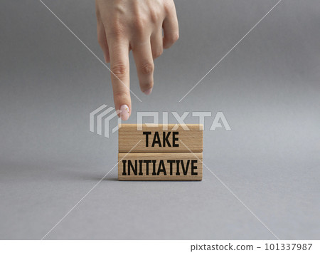 Take initiative symbol. Wooden blocks with words Take initiative. Businessman hand. Beautiful grey background. Business and Take initiative concept. Copy space. Take initiative symbol. Wooden blocks with words Take initiative. Businessman hand. Beautiful grey background. Business and Take initiative concept. Copy space. 101337987