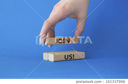 Join us symbol. Concept word Join us on wooden blocks. Beautiful blue background. Businessman hand. Business and Join us concept. Copy space Join us symbol. Concept word Join us on wooden blocks. Beautiful blue background. Businessman hand. Business and Join us concept. Copy space 101337998