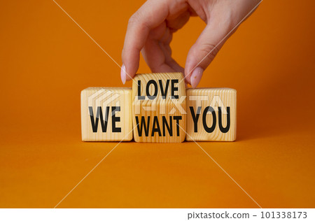 We love and want You symbol. Businessman Hand turns cubes and changes word We want you to We love you. Beautiful orange background. Business and We love and want You concept. Copy space 101338173