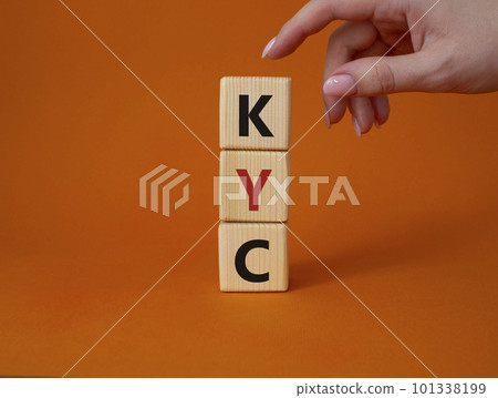 KYC - Know Your Customer. Wooden cubes with word KYC. Businessman hand. Beautiful orange background. Business and Know Your Customer concept. Copy space. 101338199