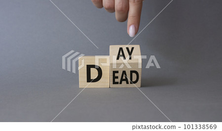 Day of the Dead symbol. Businessman hand points at turned wooden cubes with words Day of the Dead. Beautiful grey background. Day of the Dead concept. Copy space. Day of the Dead symbol. Businessman hand points at turned wooden cubes with words Day of the Dead. Beautiful grey background. Day of the Dead concept. Copy space. 101338569