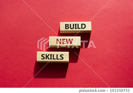 Build New skills symbol. Concept word Build New skills on wooden blocks. Beautiful red background. Business and Build New skills concept. Copy space Build New skills symbol. Concept word Build New skills on wooden blocks. Beautiful red background. Business and Build New skills concept. Copy space 101338731
