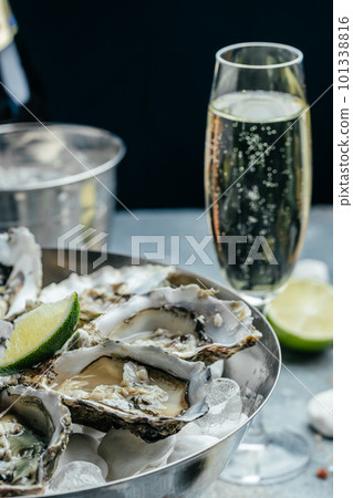 Fresh oysters with lemon and ice. Restaurant delicacy. oysters dish. Oyster dinner with champagne in restaurant 101338816