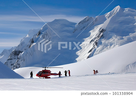 Search and rescue operation in mountains. Medical rescue helicopter landing in snowy mountains. Created with Generative AI 101338904