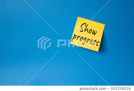 Progress symbol. Orange steaky note with words Show progress. Beautiful blue background. Business and Show progress concept. Copy space. Progress symbol. Orange steaky note with words Show progress. Beautiful blue background. Business and Show progress concept. Copy space. 101339216