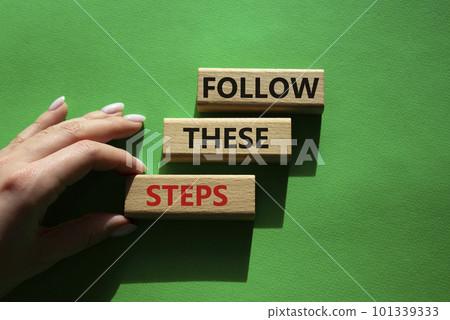 Follow these steps symbol. Wooden blocks with words Follow these steps. Beautiful green background. Businessman hand. Business and Follow these steps concept. Copy space. Follow these steps symbol. Wooden blocks with words Follow these steps. Beautiful green background. Businessman hand. Business and Follow these steps concept. Copy space. 101339333